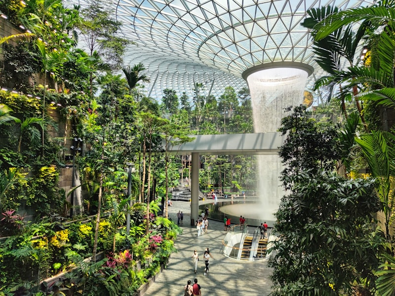 Jewel Changi Airport Rain Vortex surrounded by tropical landscaping